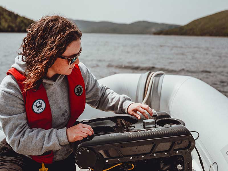 Rebecca Brushett with a Deep Trekker ROV on a boat in Newfoundland